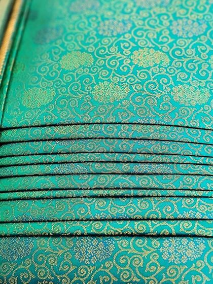 Another view of the back of the folded turquoise saree.