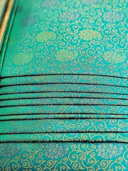 Another view of the back of the folded turquoise saree.