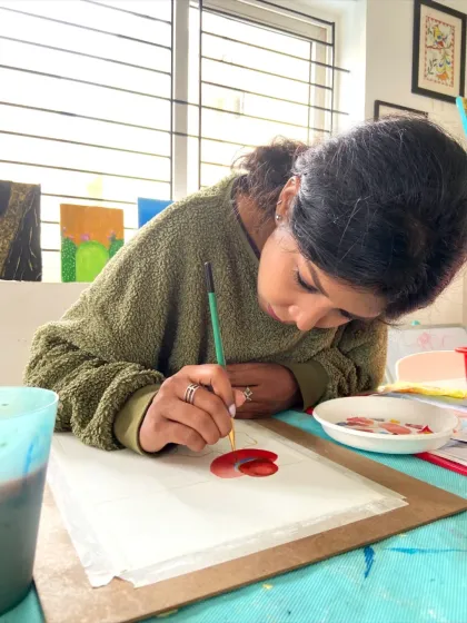 A student in our watercolor course working on a painting of a lotus. The course teaches you how to control the delicate and flowing nature of watercolors.