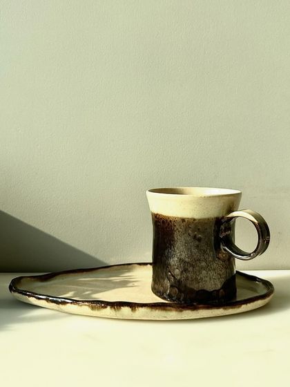 The complete set: a mug and plate from the Shibui Collection. This tableware is designed to bring a touch of handcrafted beauty to your home.