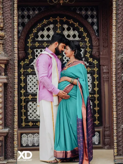An intimate pose with the couple forehead-to-forehead, framed by a beautifully carved traditional door.