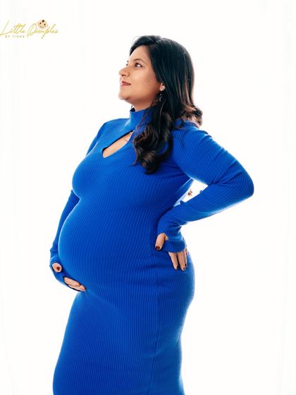 A classic three-quarter portrait. The simple dress and bright lighting create a fresh and modern look.