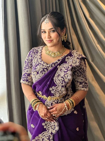 The full look. Ruchita's purple saree with intricate silver embroidery is beautifully complemented by a soft glam makeup look that enhances her natural features.