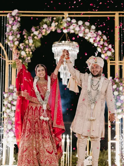 A grand and joyous moment as the couple celebrates their union. The bride's makeup remained flawless, even under the shower of petals and bright lights.