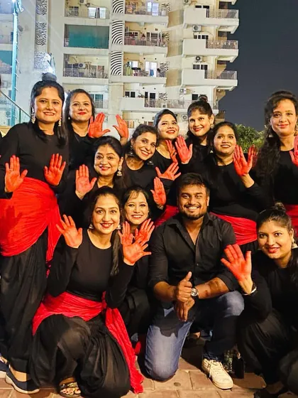 My performance group for a Durga Pooja event, dressed in a striking black and red theme for their 'Adiyogi' performance.