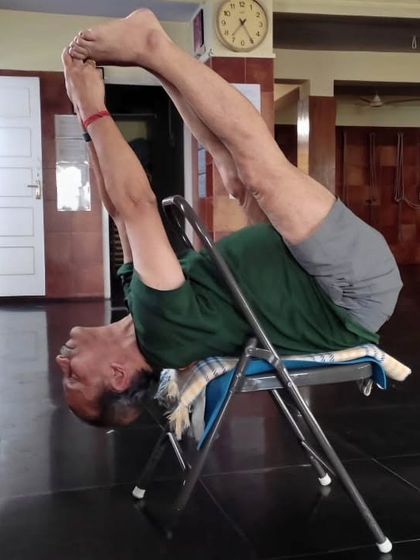 A demonstration of a variation of Urdhva Mukha Paschimottanasana using a chair. This is from an online class, showing how we can achieve deep stretches with home props.