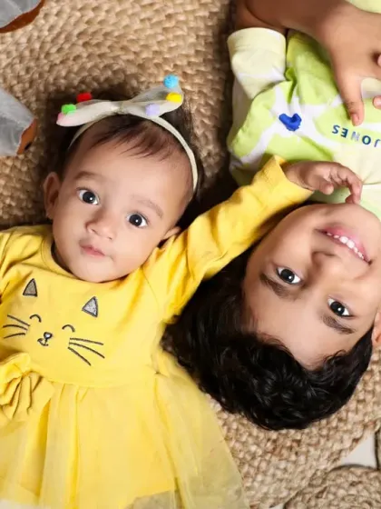 Our studio is perfect for capturing the special bond between siblings. This overhead shot of a brother and his baby sister on a woven jute rug is a heartwarming example of a sibling photoshoot.
