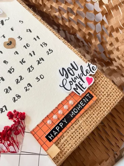 A close-up on the "You Complete Me" and "Happy Moment" stickers on this scrapbook. It’s these little affirmations that add so much warmth to the memory book.