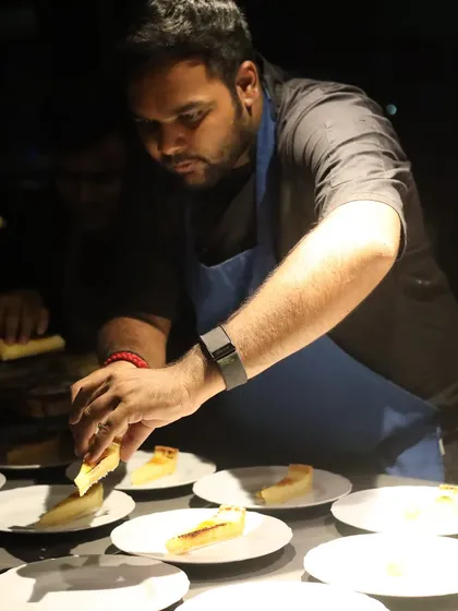 A moment of intense focus while plating dessert for a pop-up dinner in Hyderabad. Every slice must be placed perfectly.