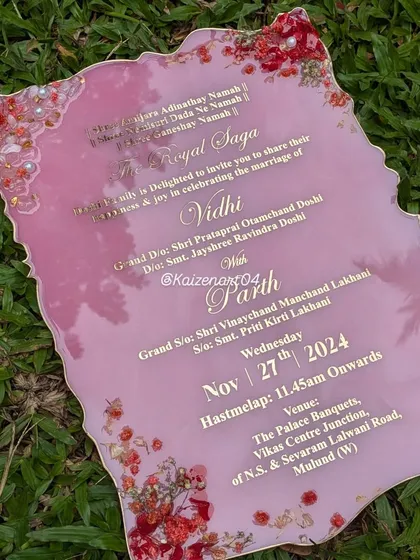 This image shows a collection of my wedding-related artworks, including a beautiful pink resin Kankotri. It's a unique way to make your wedding announcement unforgettable.