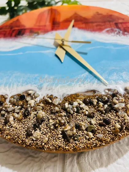 A close-up on the textured shore of my Jagannath Puri wall clock, crafted with real sand and stones to bring the feeling of the holy city's coastline right into your home.