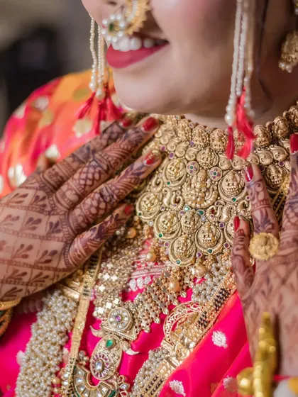A detailed shot of the bride's magnificent temple jewelry necklace, a masterpiece of traditional craftsmanship.