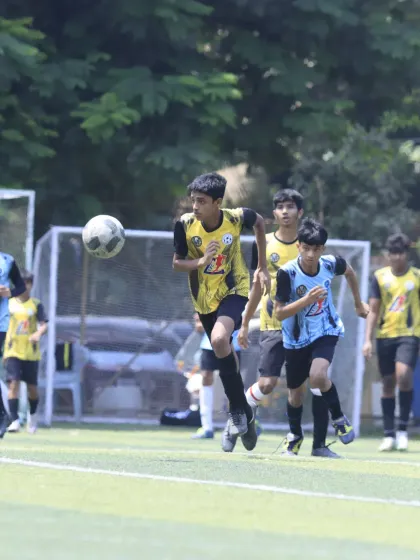 A player on the run, carrying the ball forward with speed and purpose during the U-15 semi-final. This highlights the attacking mindset we encourage.