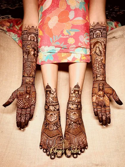 A full bridal mehendi set, where the heavy figure work on the hands is perfectly matched with royal elephant and peacock designs on the feet.