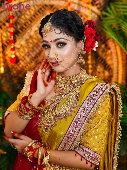 This pose highlights the intricate details of the makeup, especially the eye work and the traditional nose ring.