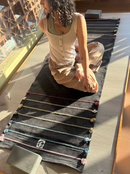 Preparing for a restorative session with props like blocks and a comfortable mat. Creating a supportive environment is key to a deep and nourishing practice.