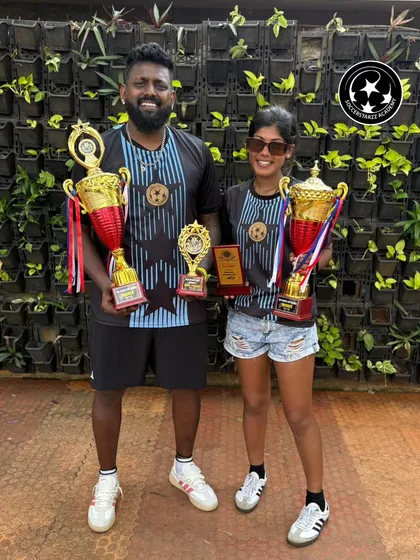 A double celebration for our coaching duo. Coaches Shruti and Allwyn holding their trophies, with the Best Coach award being the cherry on top. A testament to their winning combination.