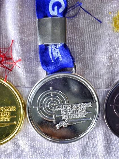 A close up of the gold, silver, and bronze medals earned by our shooters. Each one represents a milestone in an athlete's journey and a success story for our academy.