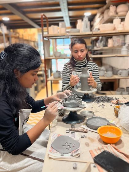 Our studio is a space for focus and fun. Here, students in a taster session are learning the basics of hand-building and wheel throwing with guidance from our instructors.