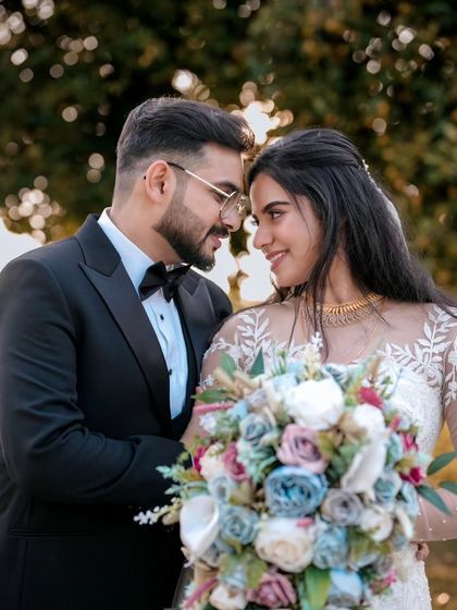 A beautiful moment between the bride and groom after their Christian wedding ceremony. The groom's classic black tuxedo is timeless.
