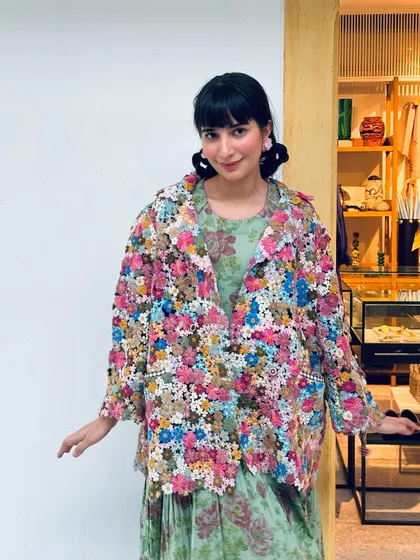 A playful winter look featuring a jacket made entirely of crochet flowers, showcasing my love for texture and craft.