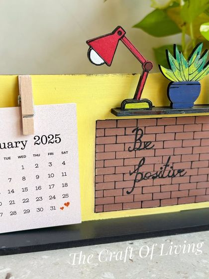 "Be Positive." This wooden desk calendar features a motivational message against a brick wall design, a great daily reminder to stay optimistic.