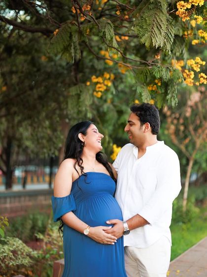 The best moments are often the unscripted ones. The genuine laughter between this couple during their outdoor maternity shoot is what makes this photo so special.