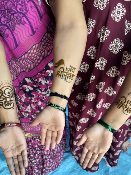 A trio of arms showcasing different styles of 'Jai Shree Ram' calligraphy in henna. It was a day of immense faith and unity.