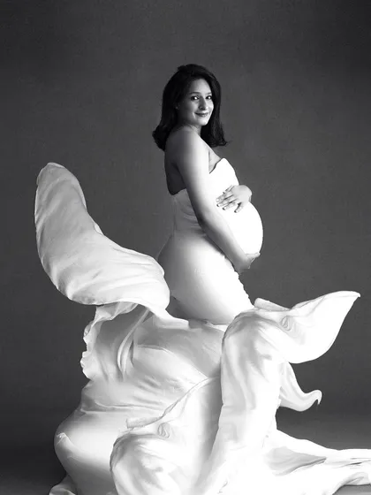 The drama of black and white photography is perfect for creating fine-art maternity portraits. The contrast between the flowing fabric and the simple background makes this a powerful and artistic image.