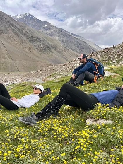 In the heart of the hills, I find a solace so divine. This moment of rest in a field of flowers during a mountain trek is a reminder of the peace that comes when we allow ourselves to simply be present in nature.