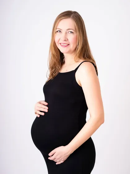 A simple black dress is a timeless choice for a maternity session. It creates a classic, sophisticated look that beautifully highlights the curve of your baby bump. This mom-to-be was glowing with joy.