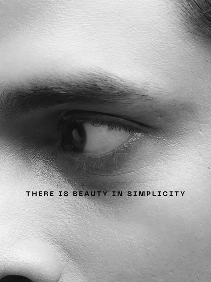 A minimalist black and white close-up of an eye. This fine art shot uses simplicity and text to convey a message, focusing on the beauty in simple forms.