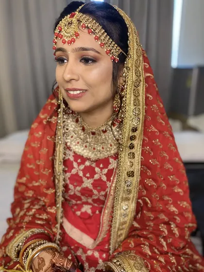 The complete look for my stunning Punjabi bride. Her traditional attire, intricate jewelry, and my classic makeup artistry come together for a look of pure elegance.