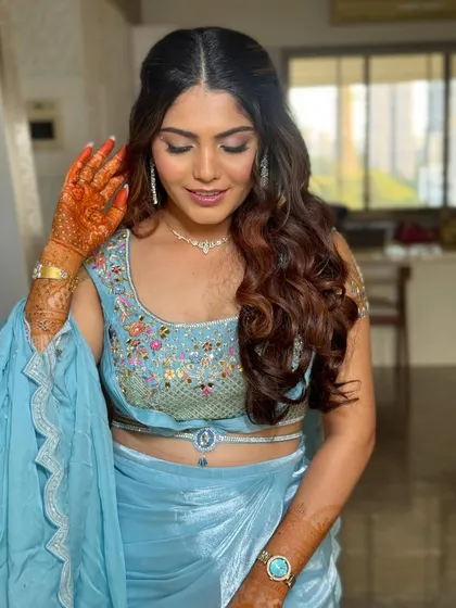 This pose highlights the henna and the soft flow of the hair. The hairstyle is versatile enough to complement both traditional and contemporary outfits.