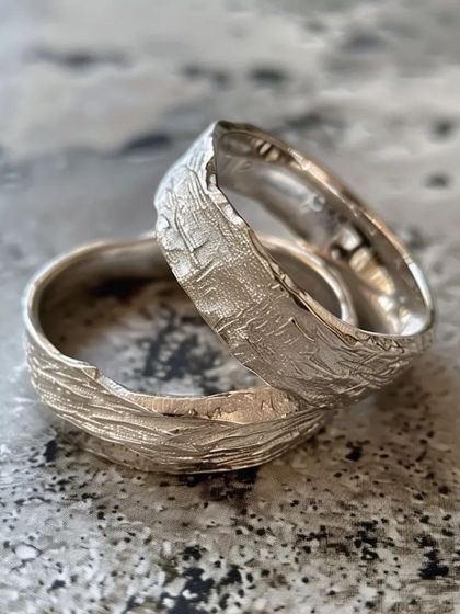 A close-up of the beautifully textured silver rings made in our workshop. The organic, reticulated surface is achieved through controlled heating techniques.