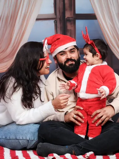 A warm and happy family portrait from a Christmas session, with everyone in Santa hats.