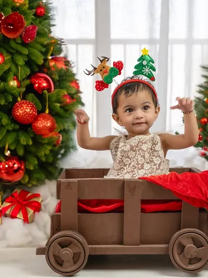 All aboard the Christmas express. This little one is ready to deliver presents in her festive wagon.