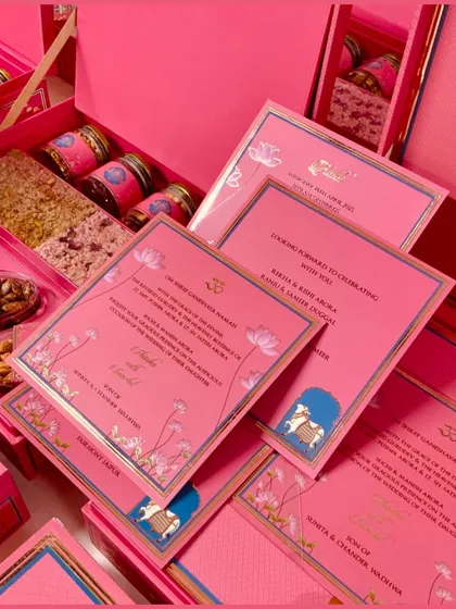 A complete view of our Pichwai-themed invitation box, displaying the beautifully printed cards alongside the curated edibles, including nut slabs and dry fruit jars.