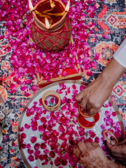 A close-up of the chooda ceremony, where the bride's bangles are dipped in milk and rose petals. I ensure even the smallest details of these rituals are picture-perfect.
