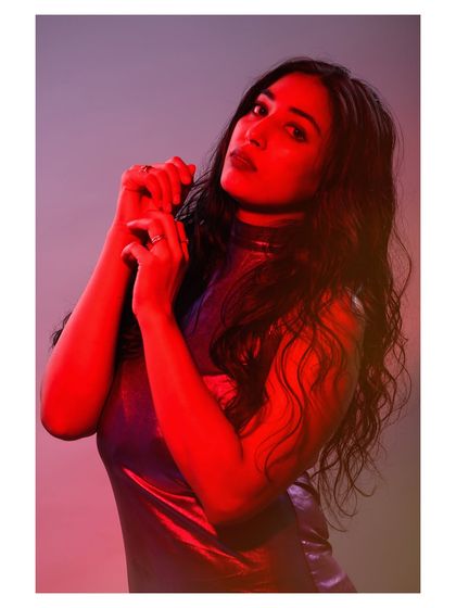 A portrait using colored gels to paint with light. The red light casts dramatic shadows and creates a bold, emotional atmosphere that is both modern and intense.