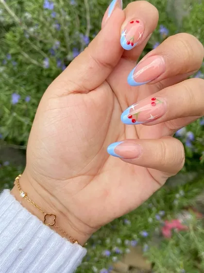 So cute and perfect for summer. This design features a simple baby blue French tip with tiny, hand-painted red cherries for a sweet and playful touch.