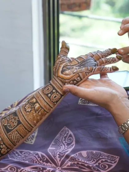 A candid moment of applying the final touches to a bridal mehndi. It's all about precision and patience to get that perfect finish.