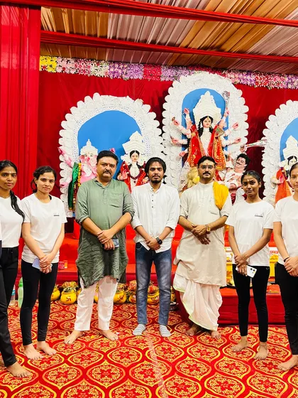 Posing with my team and event organizers at a Navratri Mahotsav in Greater Noida, where we performed a special themed yoga sequence.