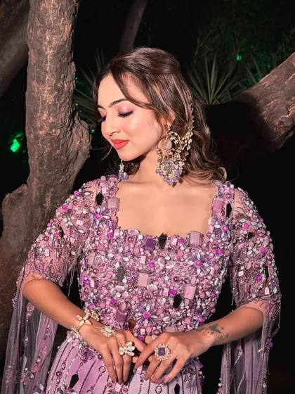 A close-up of the Haldi bridal glam. The soft pink and purple eyeshadow tones perfectly match the embellishments on her beautiful lavender outfit.
