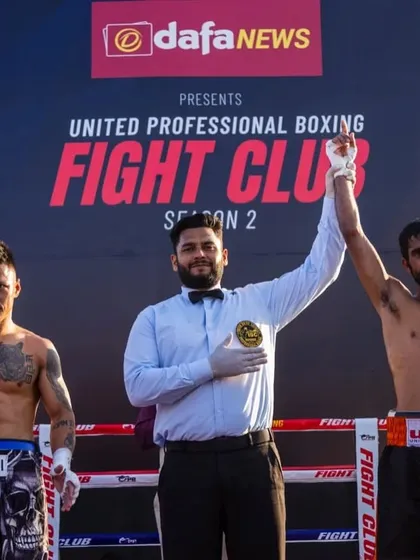 A hard-earned victory. My fighter's hand is raised after a tough professional bout.