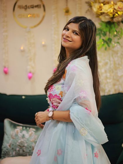 A closer look at the soft blue pastel lehenga, highlighting the intricate floral embroidery on the blouse and the organza dupatta.