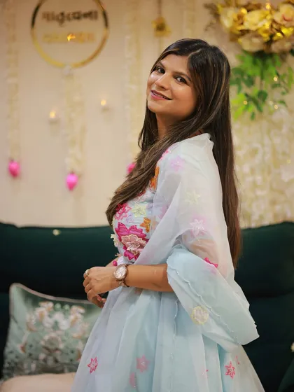A closer look at the soft blue pastel lehenga, highlighting the intricate floral embroidery on the blouse and the organza dupatta.