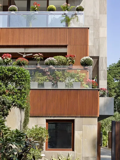 The details matter in sustainable design. Here, the warmth of the acetylated wood is complemented by flowering plants on the balconies, creating a vibrant, living facade that connects residents with nature.