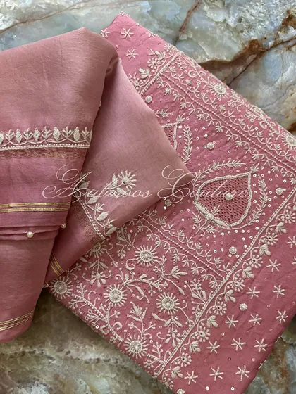 A folded view of the suit, emphasizing the rich texture of the silk chanderi and the detailed embroidery.
