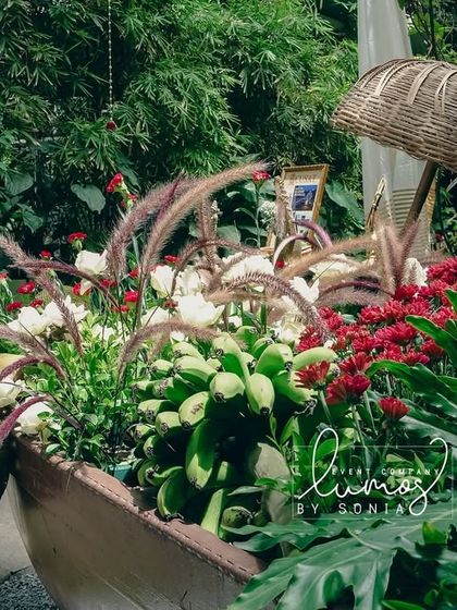 A close-up of the lush greenery and vibrant flowers within the decorative boat, highlighting the freshness and creativity of the design.